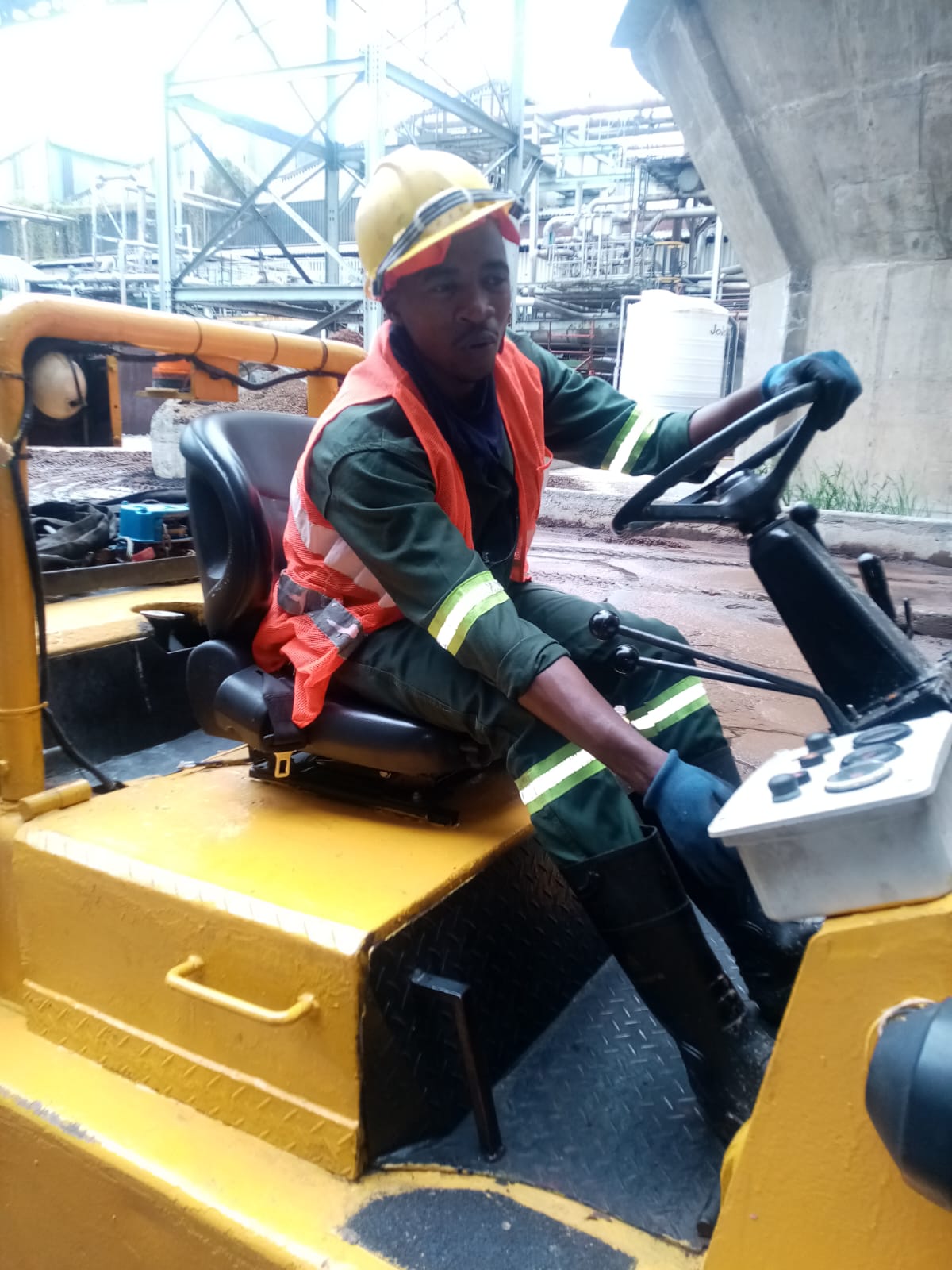 Team member operating industrial grounds maintenance equipment